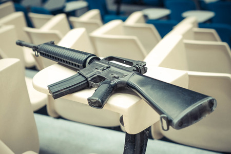 A rifle in a lecture room / Armed campus conceptの写真素材