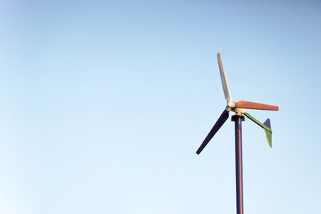 Wind mill for producing electricity with blue sky backgroundの写真素材