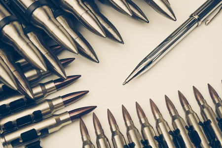 Pen vs. Bullet / Freedom of the press is at risk concept / World press freedom day conceptの写真素材