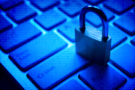 A security lock on computer keyboard with blue digital background