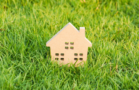 Wooden house on green grass / Eco houseの写真素材