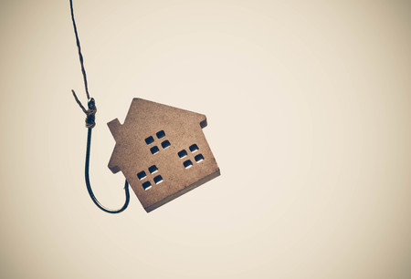 A house on a fish hook / Risks and negative sides of buying a house conceptの写真素材