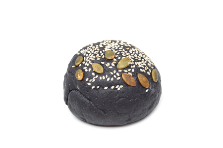 Charcoal bun with sesame and pumpkin seeds toppingの写真素材