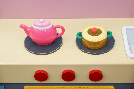 Toys for kids - kitchen set consisting of teapot, pot, and cookerの写真素材