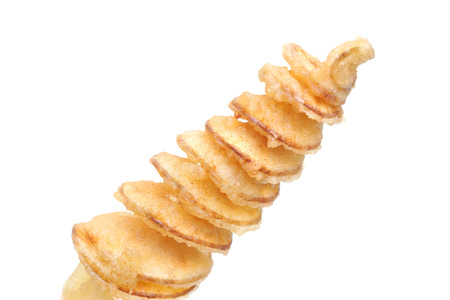 Closeup of a stick of spiral fried potatoの写真素材