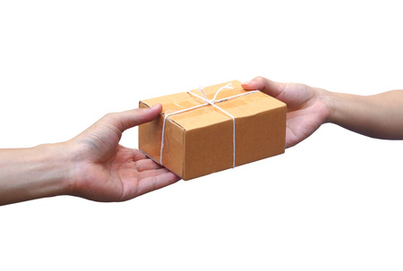 Hand sending a cardboard box to a customer / Parcle deliveryの写真素材