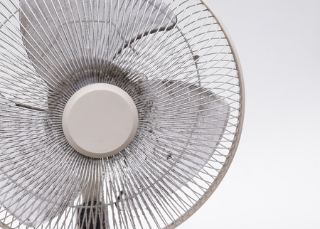 Dirty fan full of dust on the fan blade and grill may causing allergy and health problemの写真素材