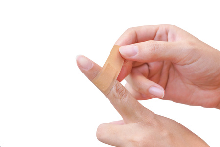 Female hand with first aid plaster isolatedの写真素材