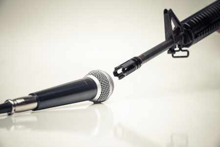 Microphone vs. Rifle / Freedom of the press is at risk concept / World press freedom day concept with copy space to add textの写真素材