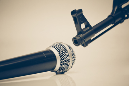 Microphone vs. Rifle / Freedom of the press is at risk concept / World press freedom day conceptの写真素材