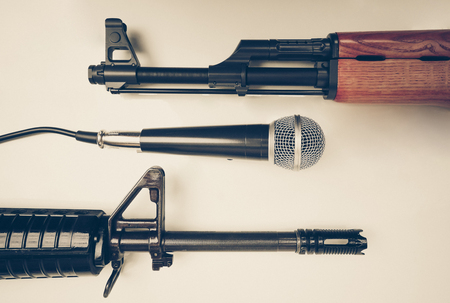 Microphone vs. Rifles / Freedom of the press is at risk concept / World press freedom day concept