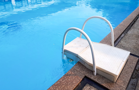 A swimming pool with a rail and a ladderの写真素材