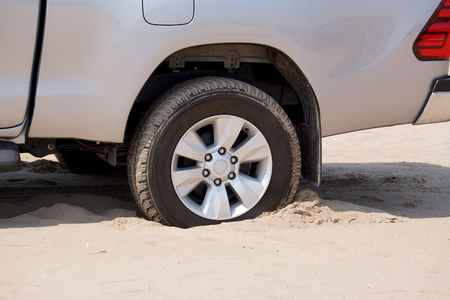 Rear wheels of a truck stuck in sand                            の写真素材