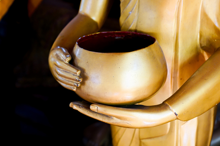 Closeup shot of Buddha statue holding a monk 's alms bowlの写真素材
