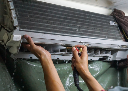 Cleaning an air conditionerの写真素材