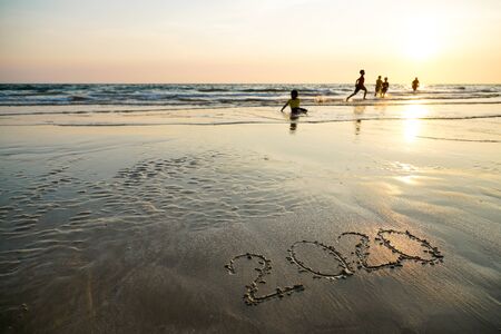 Happy New Year 2020 written on the beach