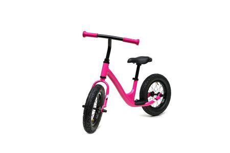 A pink balance bike isolated on white backgroundの写真素材
