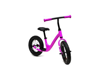 A pink balance bike isolated on white backgroundの写真素材