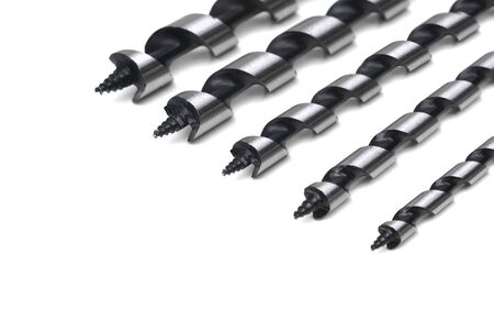 Closeup of a set of long drill bits for drilling wood isolated on white background                  ...