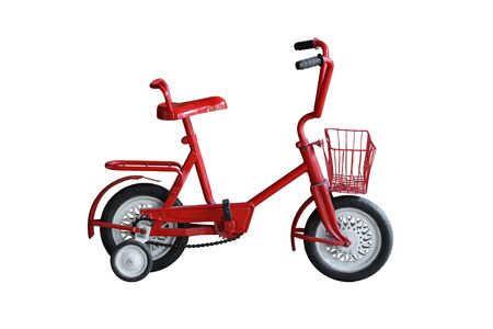 An old style bicycle for kid in red color with training wheels on isolated background                                 の写真素材
