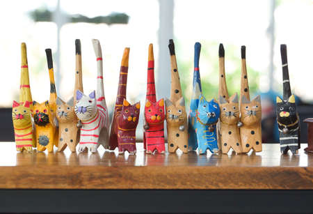 Colorful wooden cats on wooden tableの写真素材