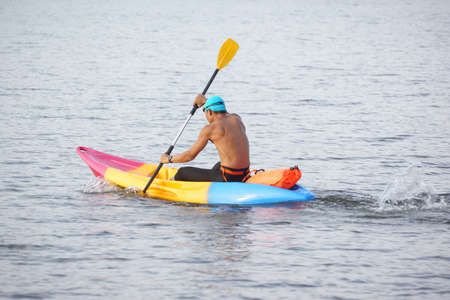 Man rowing a kayak boat in the riverの写真素材