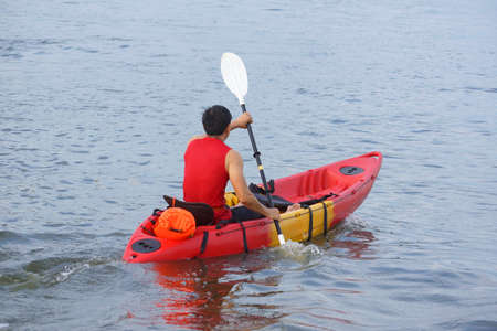 Man rowing a kayak boat in the riverの写真素材