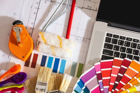 Professional decorator drawing on a house project with work tools.の写真素材