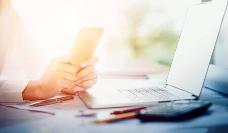 Business meeting time. Photo young account managers crew working with new startup project. Notebook on wood table. Idea presentation, analyze plans. Wide,film effectの写真素材