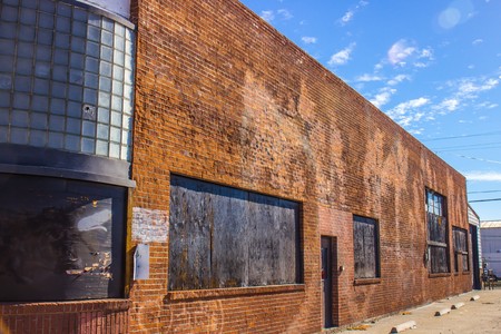 Side of Abandoned Brick Building With Curved Glassの写真素材