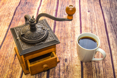 Vintage Coffee Grinder & Cup Of Coffeeの写真素材