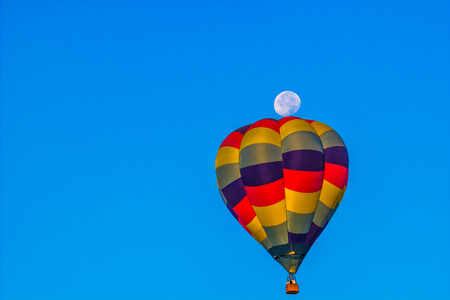 Multi Colored Hot Air Balloon In Morning With Moon Showingの写真素材