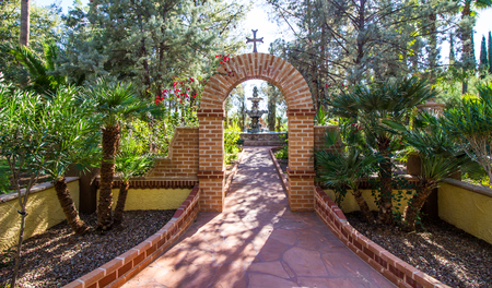 Brick Archway With Cross Leading To Fountainの写真素材