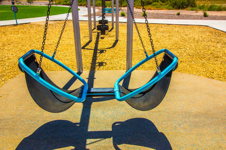Modern Dual Swing Set In Children's Playground In Public Parkの写真素材