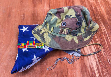 Camouflage Jungle Green Hat, American Flag & Service Ribbons On Wooden Deskの写真素材