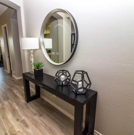 Entry Hall Way With Large Circular Mirror, Wooden Bench, Lamp And Decorator Itemsの写真素材