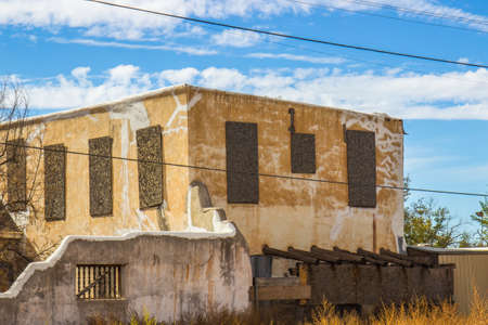 Boarded Up Windows Of Abandoned Home In Compoundの写真素材