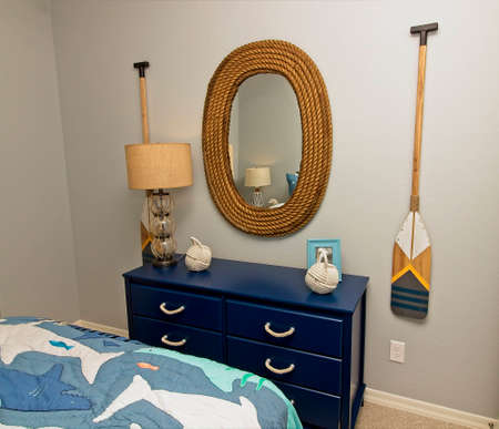 Bedroom Blue Dresser And Wall Hangings With Nautical Theme