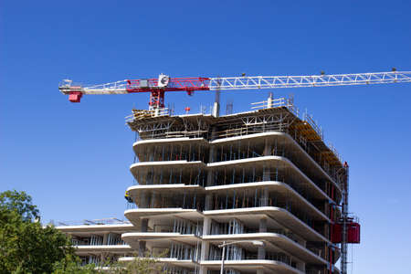 Multi Story Building Under Construction With Large Craneの写真素材