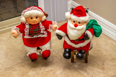 Small Mr. And Mrs. Santa Claus Sitting On Mini Chairsの写真素材