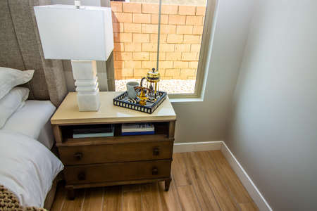 Master Bedroom Nightstand With Ceramic Lamp And Tray Of Decorative Items