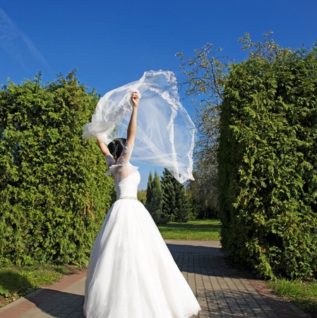 Beautiful  bride wearing white dress dancing in park.Weddingの写真素材