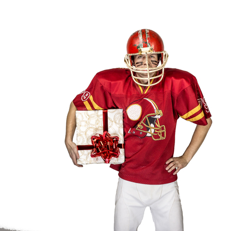 American football player in red uniform posing with big giftの写真素材