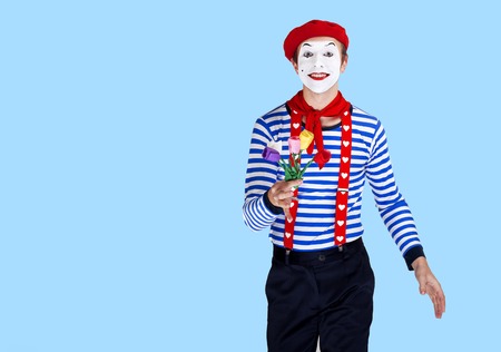 Mime with flower.Emotional funny actor wearing sailor suit, red beretの写真素材
