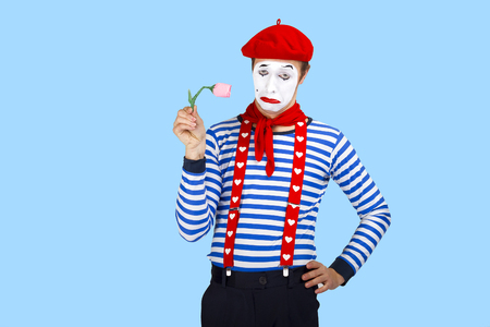 Mime with flower.Emotional funny actor wearing sailor suit, red beretの写真素材