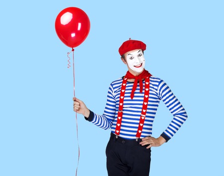 Mime with balloon.Emotional funny actor wearing sailor suit, red beretの写真素材