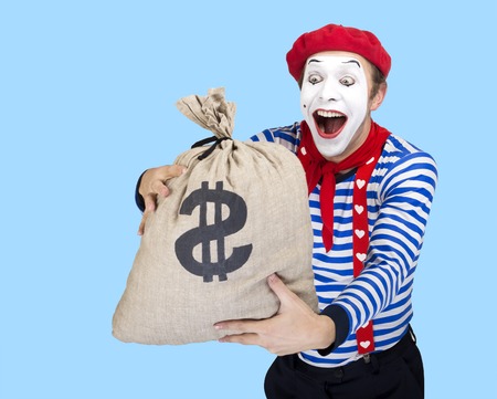 Mime with money bag.Emotional funny actor wearing sailor suit, red beretの写真素材