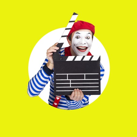 Emotional funny mime actor wearing sailor suit, red beret posing on color backgroundの写真素材