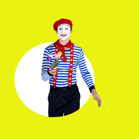 Smiling male mime with flowers.Funny actor in red beret, sailor suitの写真素材