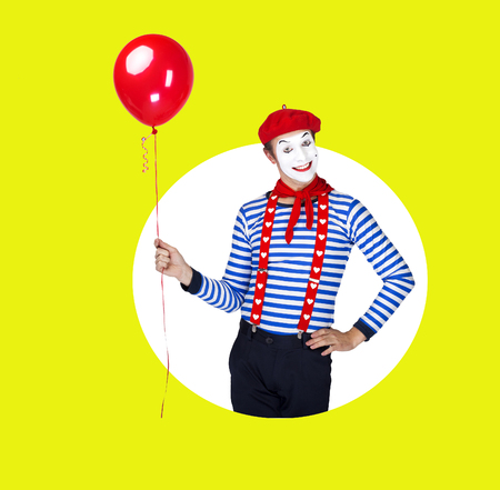 Smiling mime with balloon.Funny actor in red beret, sailor suitの写真素材
